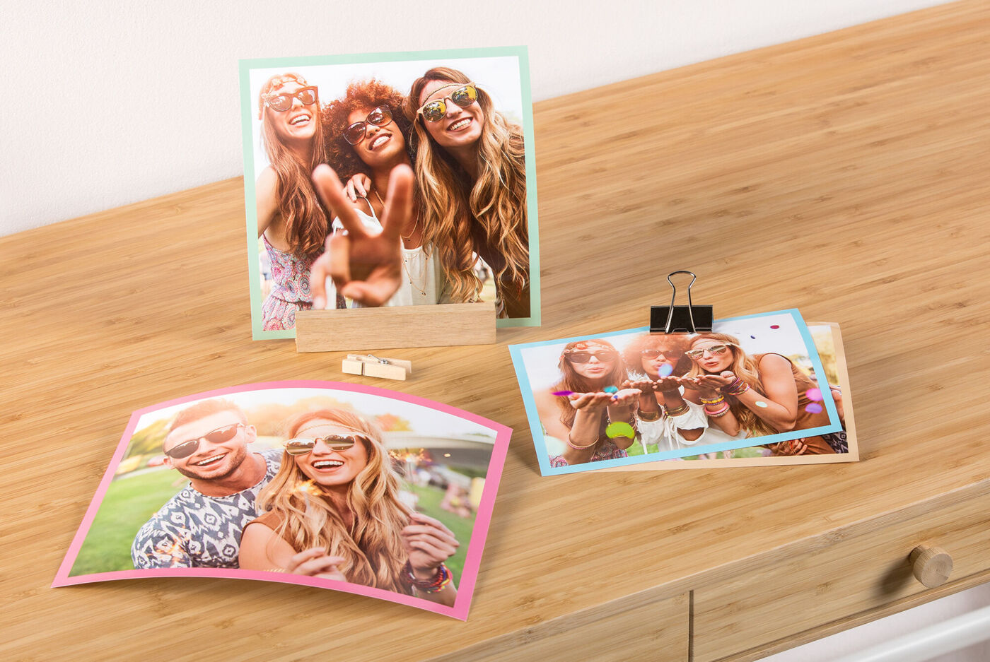 Drie kleurrijke foto's van vrolijke mensen op een tafel.